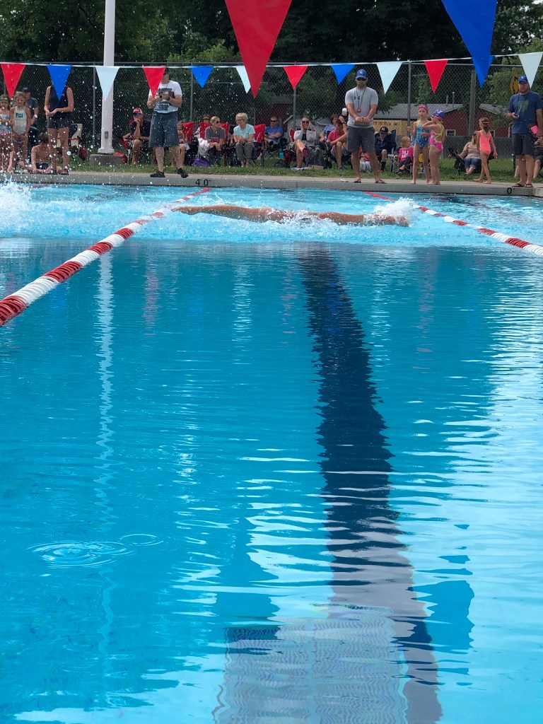 This photo portrays me swimming in a race. 